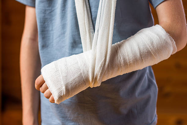 A person with their arm in a cast and sling.